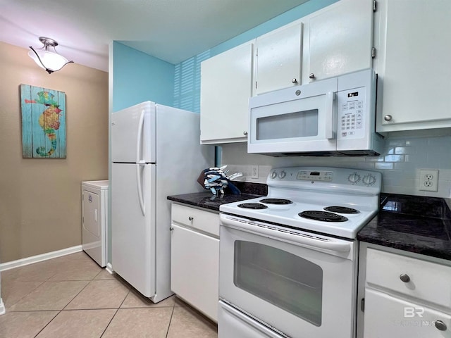 kitchen featuring white appliances, white cabinets, backsplash, washer / dryer, and light tile patterned flooring