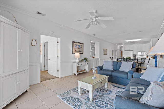 carpeted living room with ceiling fan and crown molding