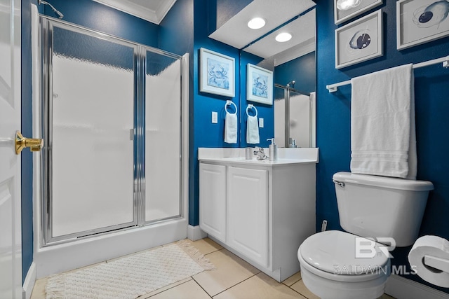 bathroom with a shower with shower door, tile floors, vanity with extensive cabinet space, toilet, and crown molding