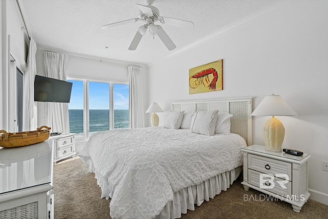 carpeted bedroom with ceiling fan, a water view, ornamental molding, and a textured ceiling