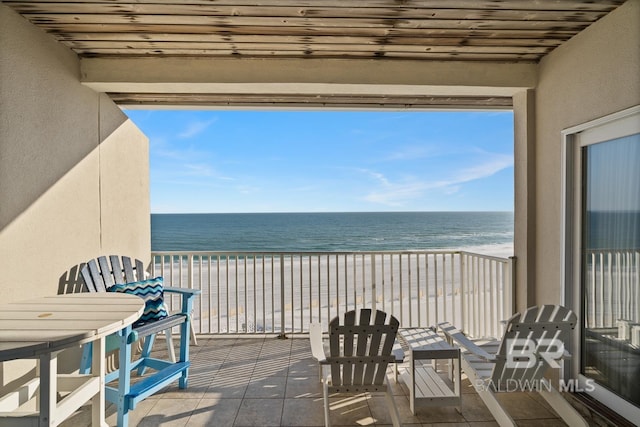 balcony with a beach view and a water view