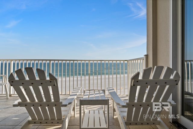 balcony featuring a water view and a view of the beach