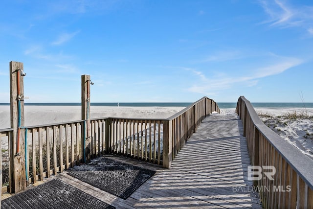 view of home's community featuring a water view and a view of the beach