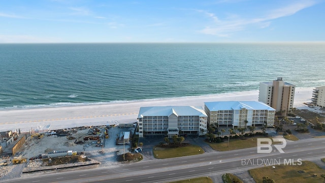 birds eye view of property featuring a water view and a beach view