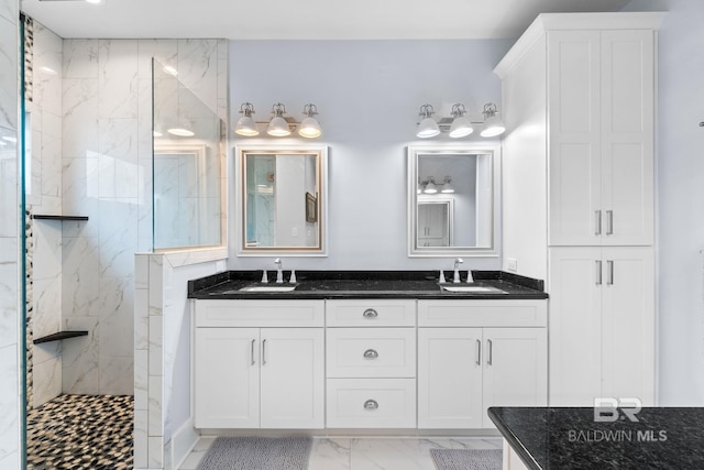 bathroom featuring a tile shower and vanity