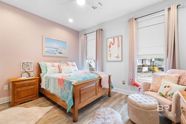 bedroom with light hardwood / wood-style flooring and ceiling fan