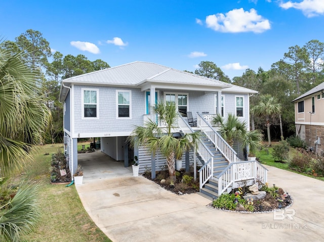 raised beach house with a carport and covered porch