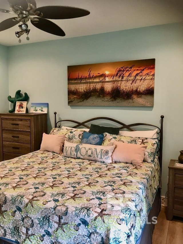 bedroom with hardwood / wood-style floors and ceiling fan