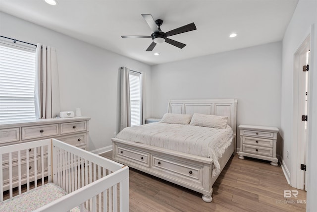 bedroom with wood finished floors, baseboards, a ceiling fan, and recessed lighting