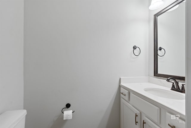 bathroom with toilet and vanity