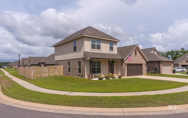 traditional-style house featuring fence, an attached garage, driveway, stucco siding, and a front yard