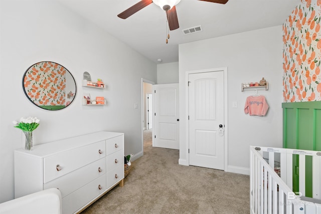 bedroom featuring baseboards, ceiling fan, light carpet, and visible vents