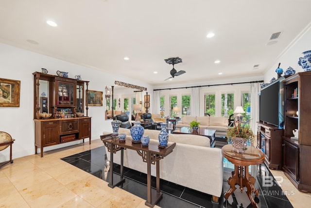 living room featuring french doors, crown molding, and light tile flooring