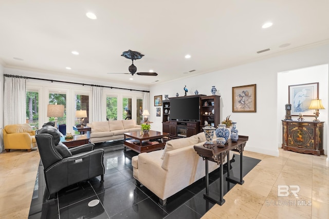 living room featuring ceiling fan, crown molding, and light tile flooring