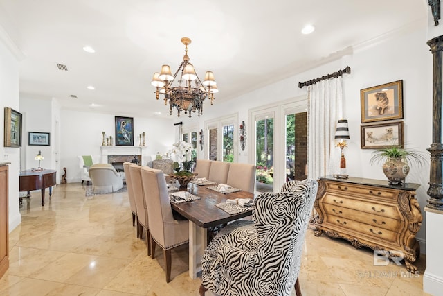 dining area with light tile floors, a chandelier, and ornamental molding