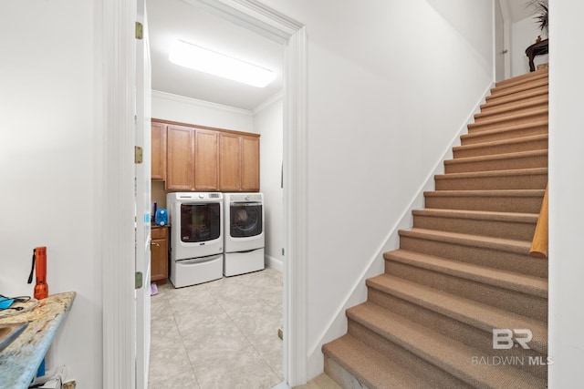 laundry room with cabinets, separate washer and dryer, crown molding, and light tile flooring