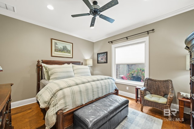 bedroom featuring ceiling fan, crown molding, and dark hardwood / wood-style flooring