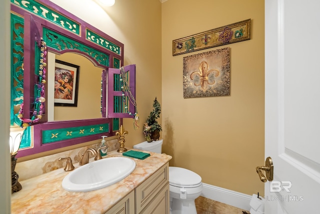 bathroom with toilet, tile flooring, and vanity