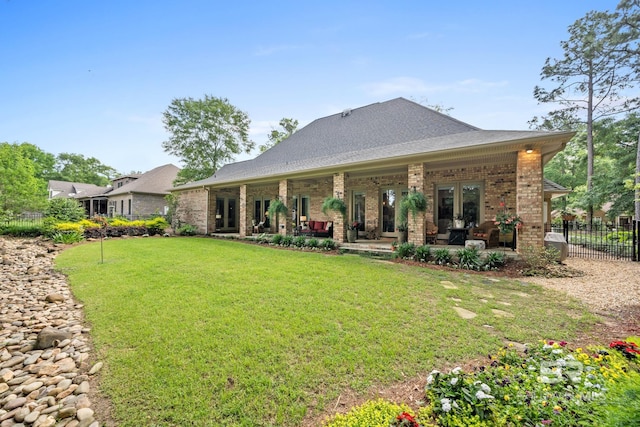 rear view of house with a yard