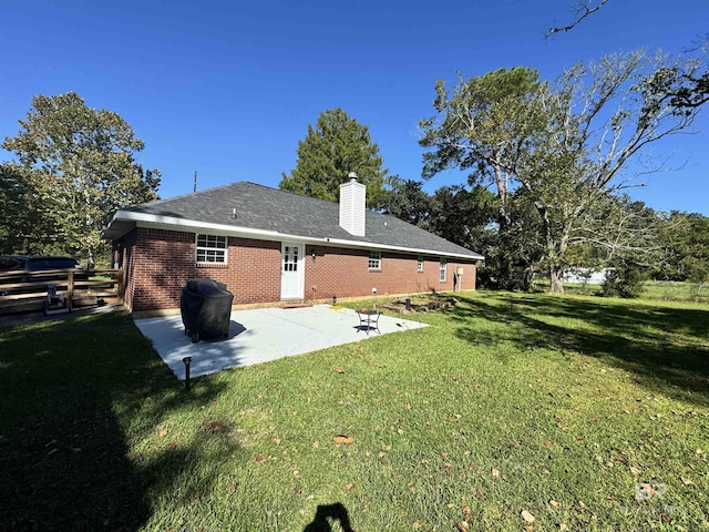 14313 Hemley Rd, Coden, AL 36523 - back of property with a chimney, a patio area, and brick siding