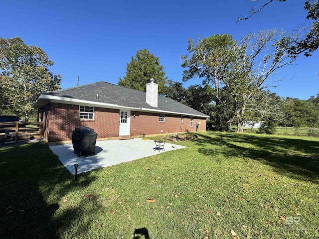 14313 Hemley Rd, Coden, AL 36523 - back of house with a patio, a chimney, and brick siding