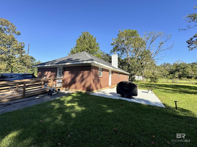 14313 Hemley Rd, Coden, AL 36523 - view of property exterior with brick siding, a chimney, and a patio area