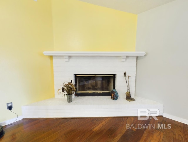 14313 Hemley Rd, Coden, AL 36523 - detailed view of baseboards, wood finished floors, and a fireplace