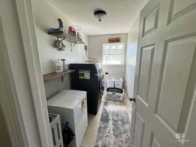 14313 Hemley Rd, Coden, AL 36523 - laundry room featuring washer and dryer, a textured ceiling, and light tile patterned floors