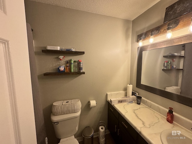 14313 Hemley Rd, Coden, AL 36523 - bathroom with a textured ceiling, toilet, and vanity