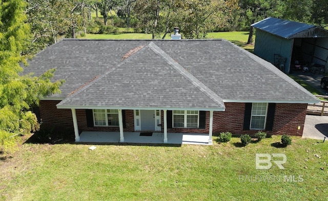 14313 Hemley Rd, Coden, AL 36523 - view of front of house with a shingled roof, a front yard, and brick siding