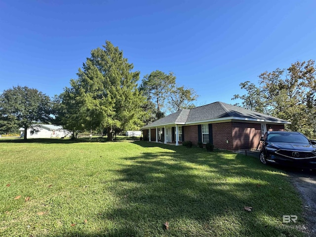 14313 Hemley Rd, Coden, AL 36523 - view of side of property with a lawn, brick siding, and a shingled roof