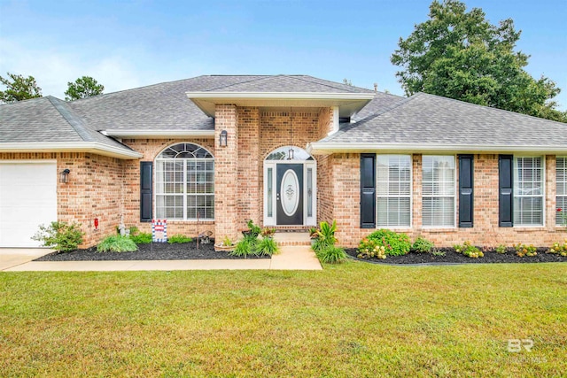 view of front of house with a front lawn and a garage