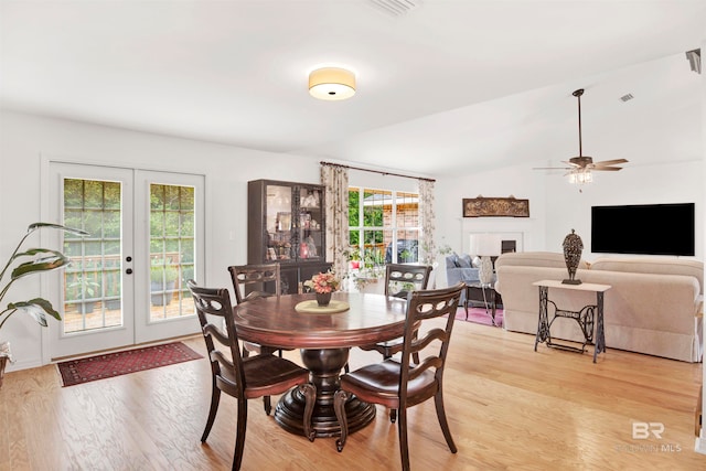 dining space with light hardwood / wood-style floors, ceiling fan, and a wealth of natural light