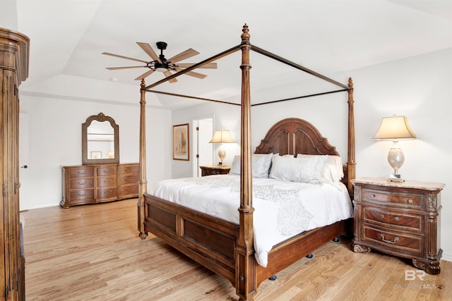 bedroom featuring lofted ceiling, ceiling fan, and light wood-type flooring