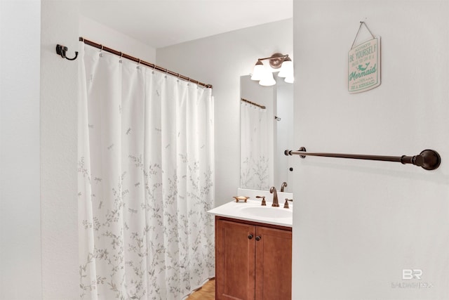 bathroom featuring wood-type flooring and oversized vanity