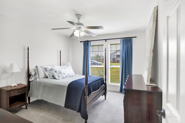 bedroom with ceiling fan and light colored carpet