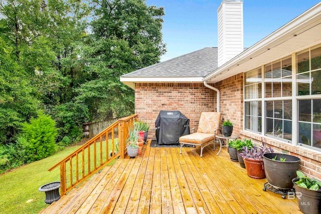 wooden terrace with a grill