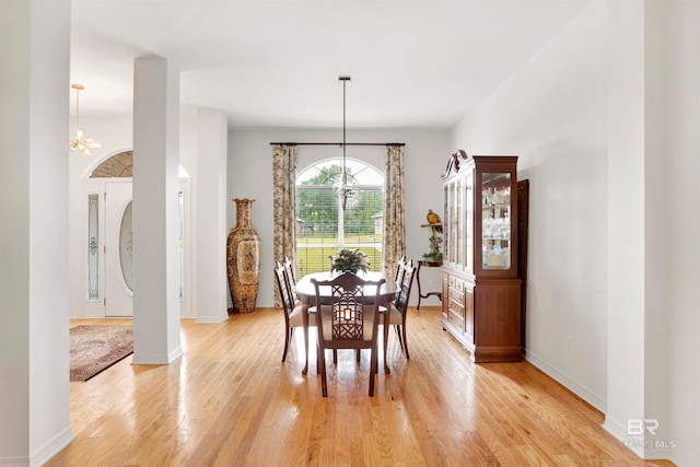 dining room with a chandelier and light wood-type flooring