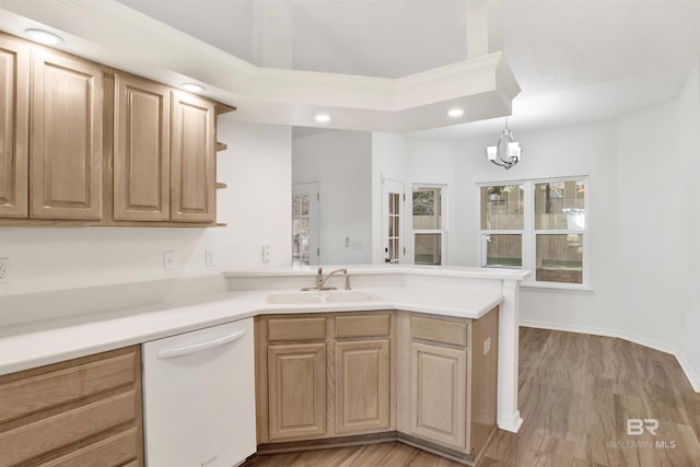 kitchen featuring dishwasher, light hardwood / wood-style floors, decorative light fixtures, and sink