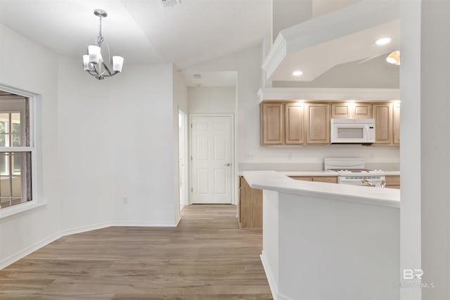 kitchen featuring light wood-type flooring, light brown cabinetry, white appliances, and an inviting chandelier