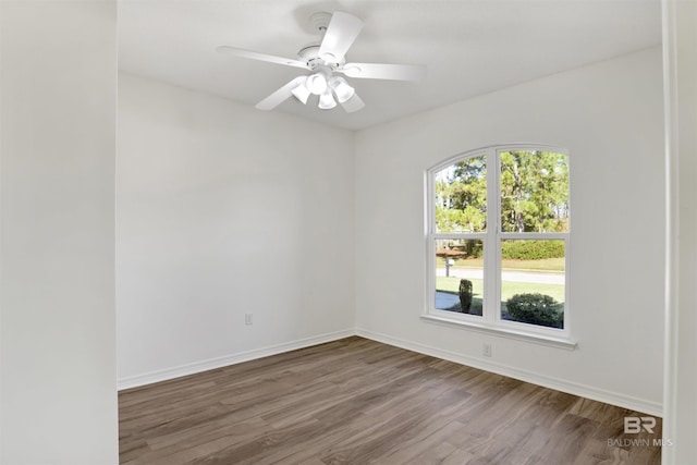 empty room featuring ceiling fan and hardwood / wood-style floors