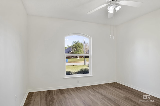 unfurnished room with ceiling fan and hardwood / wood-style flooring