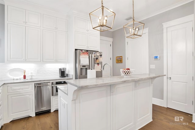 kitchen with pendant lighting, white cabinets, a kitchen island with sink, light stone counters, and stainless steel appliances