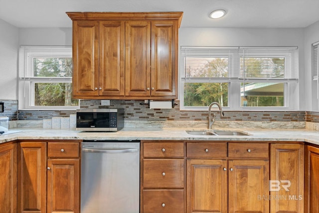 kitchen with tasteful backsplash, appliances with stainless steel finishes, sink, and plenty of natural light