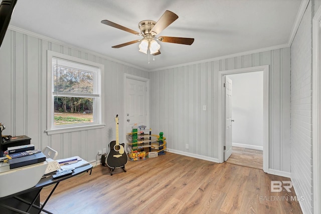 miscellaneous room featuring ornamental molding, ceiling fan, and light hardwood / wood-style flooring