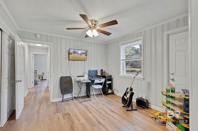 office featuring light hardwood / wood-style flooring, ornamental molding, and ceiling fan