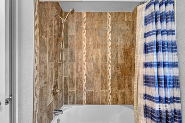 bathroom featuring shower / bathtub combination with curtain and a textured ceiling