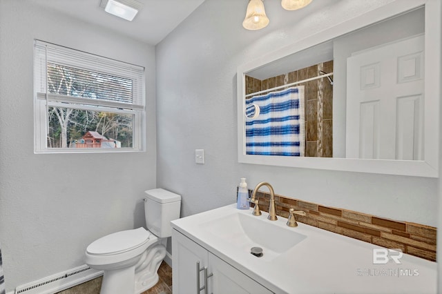 bathroom with vanity, walk in shower, toilet, and baseboard heating