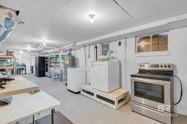 basement featuring black refrigerator and independent washer and dryer