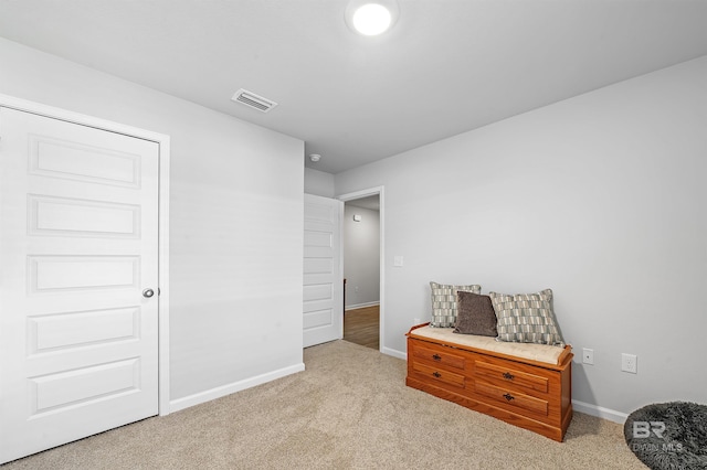 sitting room featuring carpet flooring